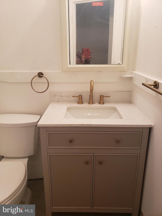 bathroom with vanity and toilet