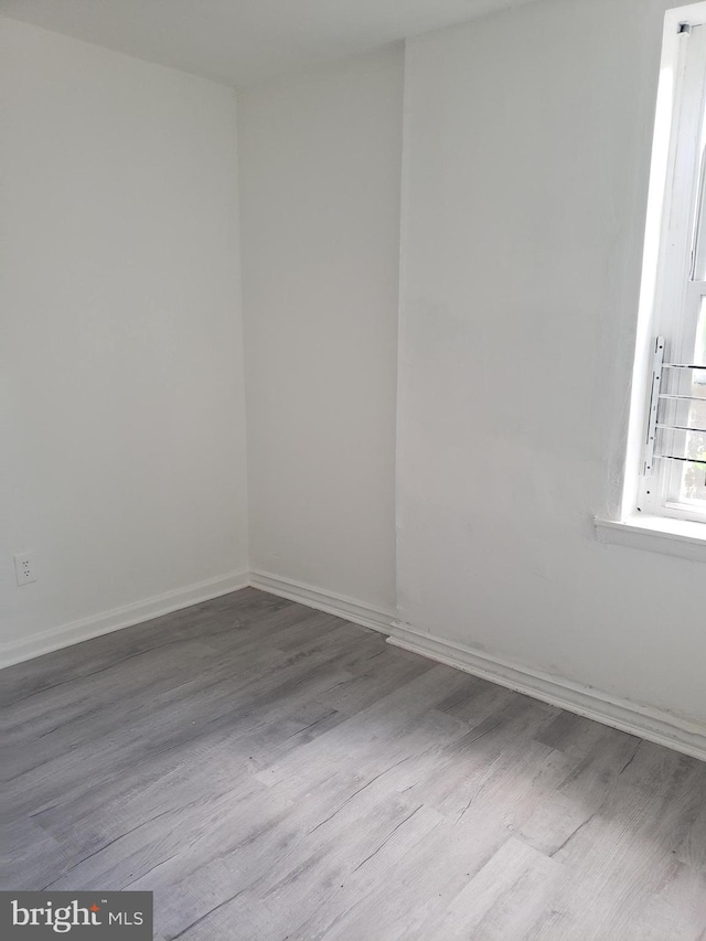 empty room with light hardwood / wood-style flooring