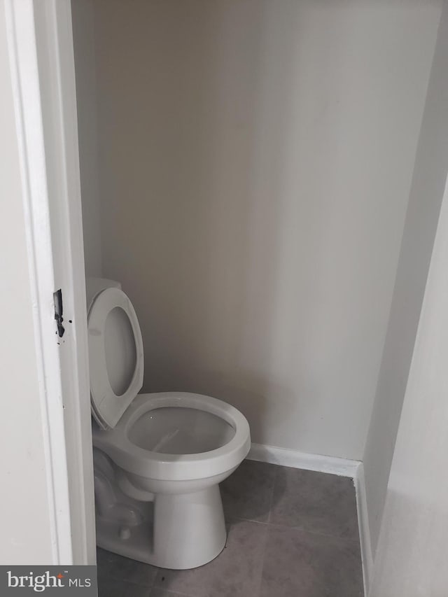 bathroom featuring tile patterned flooring and toilet