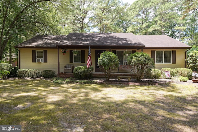 ranch-style house with covered porch and a front yard