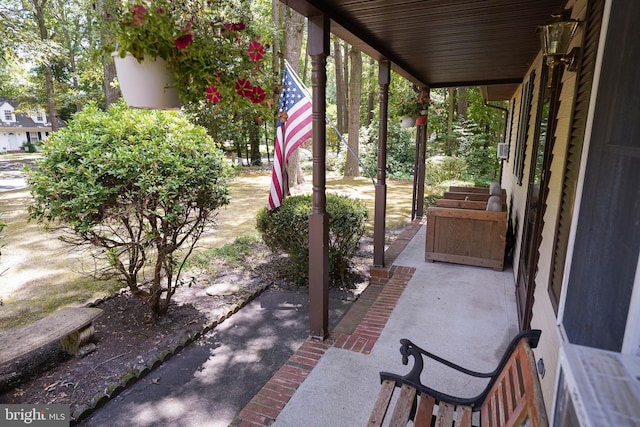 view of patio with grilling area and a porch