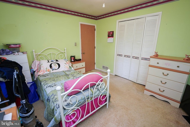 bedroom featuring a closet, light colored carpet, and ornamental molding