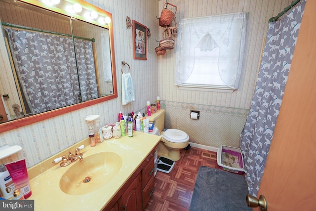 bathroom featuring vanity, curtained shower, toilet, and parquet floors