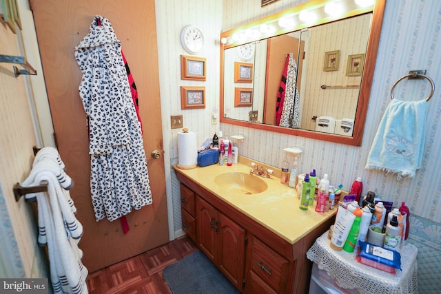 bathroom featuring vanity and parquet flooring