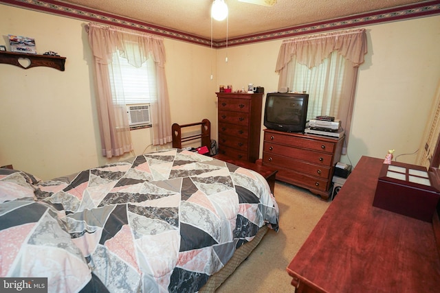 carpeted bedroom featuring ceiling fan and a textured ceiling