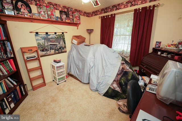 bedroom featuring a textured ceiling and carpet floors