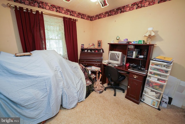 carpeted bedroom featuring a textured ceiling