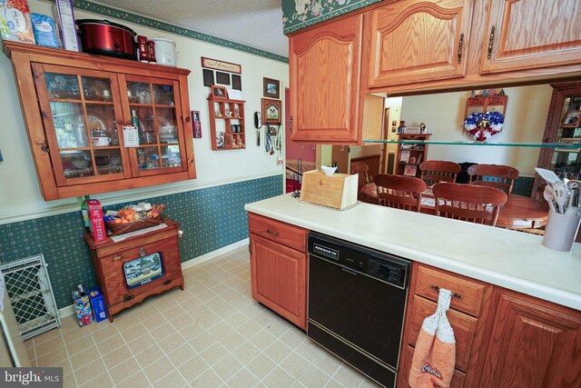 kitchen featuring a textured ceiling and black dishwasher