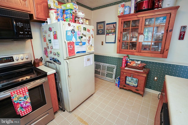 kitchen featuring stainless steel range with electric cooktop and white fridge