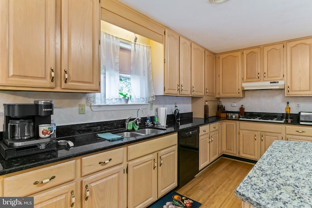 kitchen featuring light wood-type flooring, light brown cabinetry, dishwasher, dark stone countertops, and sink