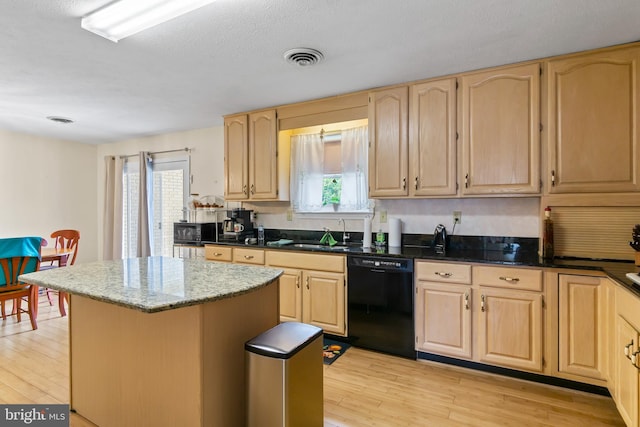 kitchen featuring dishwasher, sink, a kitchen island, and plenty of natural light