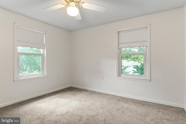 unfurnished room with ceiling fan, a healthy amount of sunlight, and carpet flooring