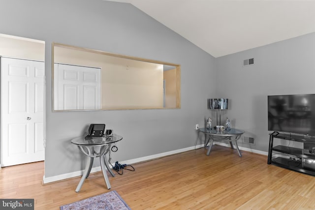 misc room featuring lofted ceiling and hardwood / wood-style flooring