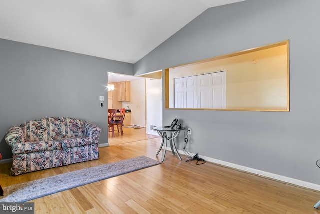 sitting room featuring lofted ceiling and wood-type flooring