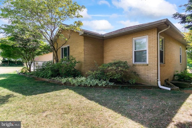 view of property exterior featuring a lawn