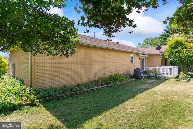 view of side of property with a yard