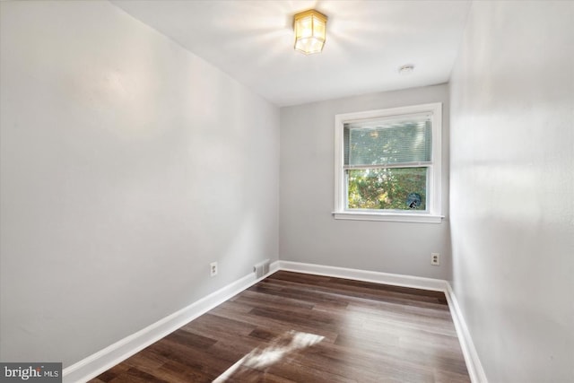 spare room with dark hardwood / wood-style floors