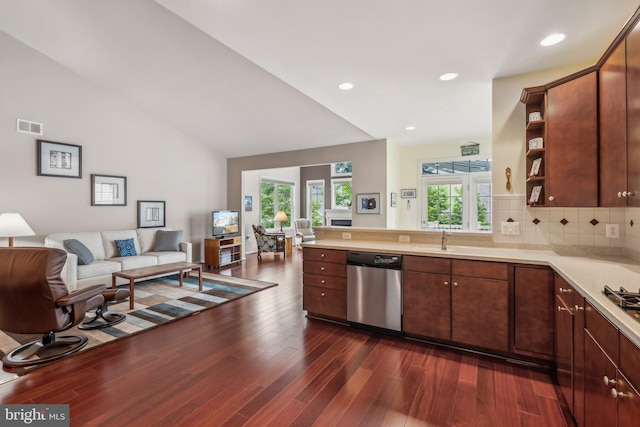 kitchen featuring decorative backsplash, dark hardwood / wood-style flooring, vaulted ceiling, sink, and dishwasher