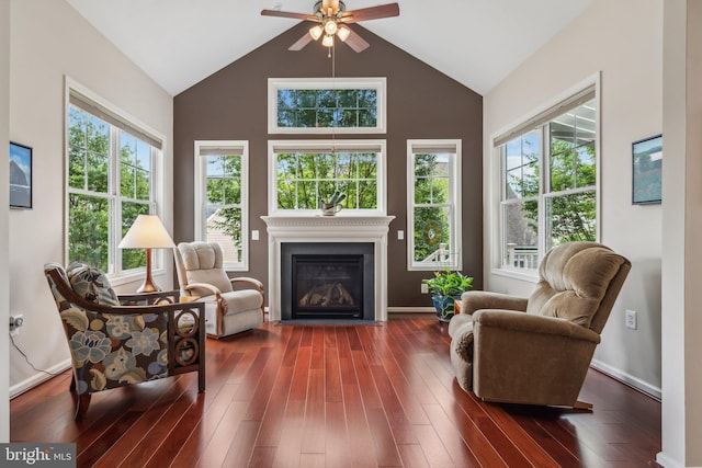 living area with dark hardwood / wood-style floors, ceiling fan, and lofted ceiling