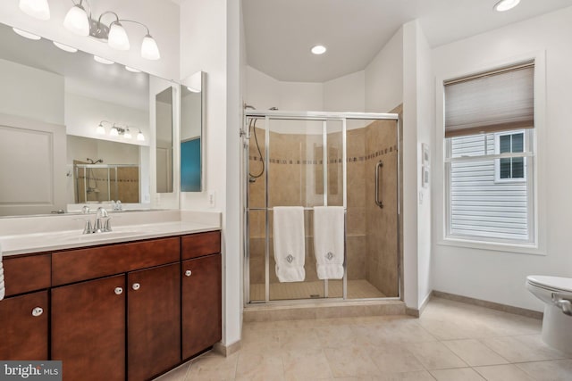 bathroom featuring tile patterned flooring, vanity, toilet, and a shower with shower door