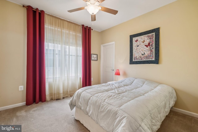 bedroom with light carpet and ceiling fan