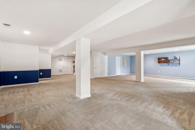 basement featuring light colored carpet