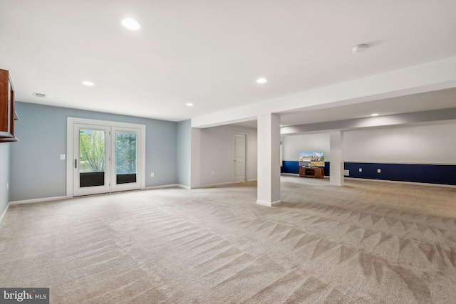 basement featuring light colored carpet