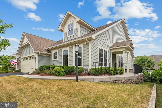 view of front of property featuring a front lawn and a garage