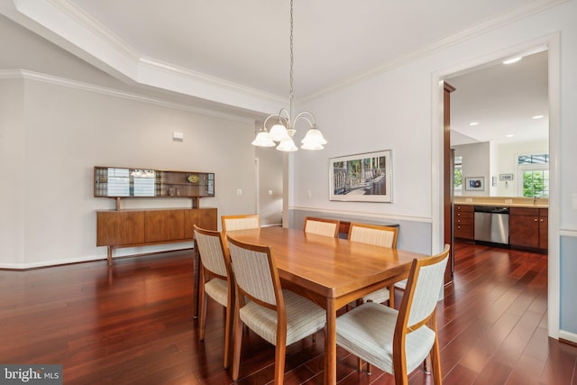 dining space with dark hardwood / wood-style flooring, crown molding, and a chandelier