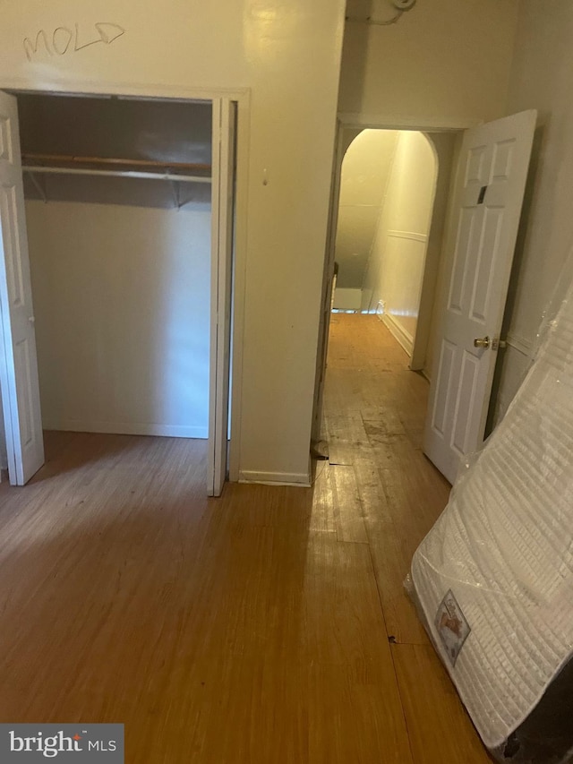 unfurnished bedroom featuring hardwood / wood-style flooring and a closet