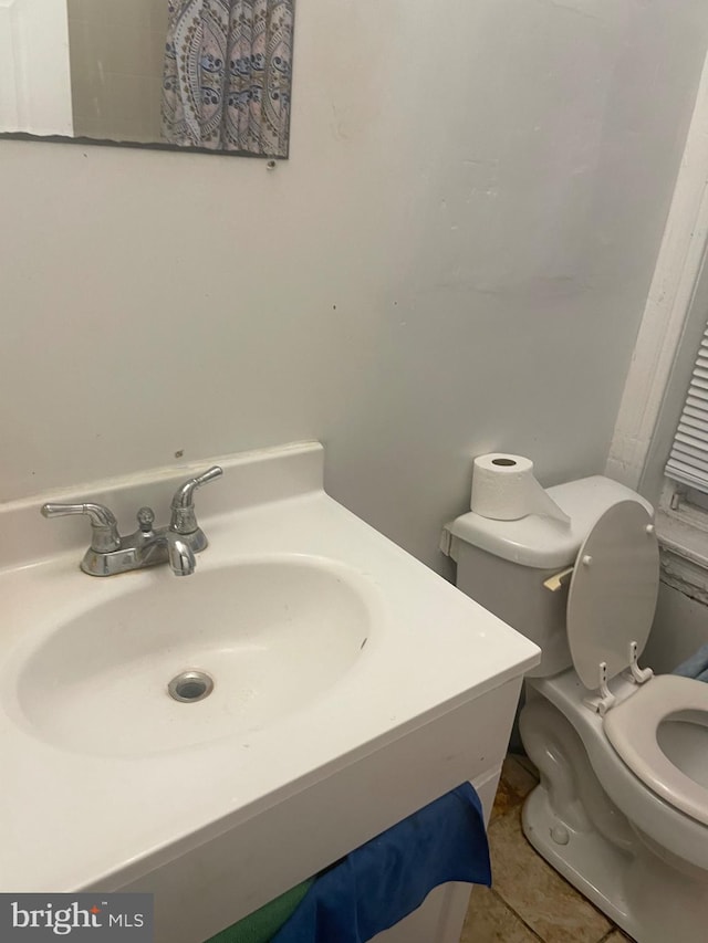 bathroom featuring tile patterned flooring, vanity, and toilet