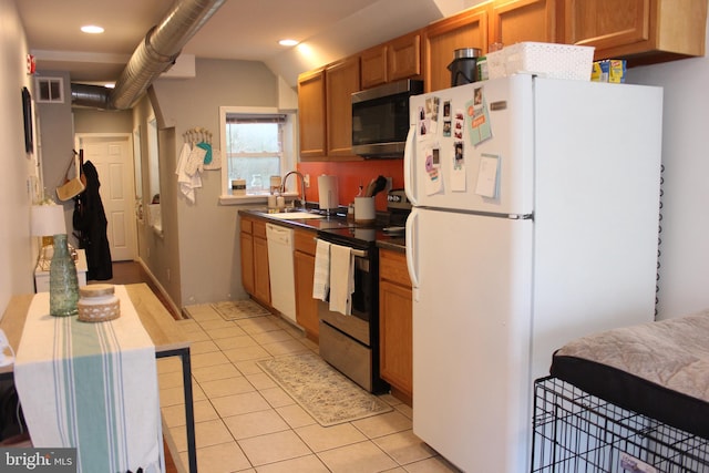 kitchen featuring light tile patterned flooring, sink, and stainless steel appliances