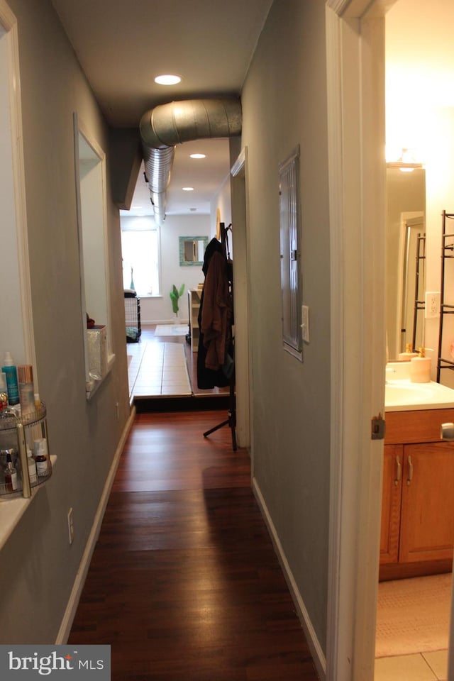 corridor featuring sink and dark hardwood / wood-style floors