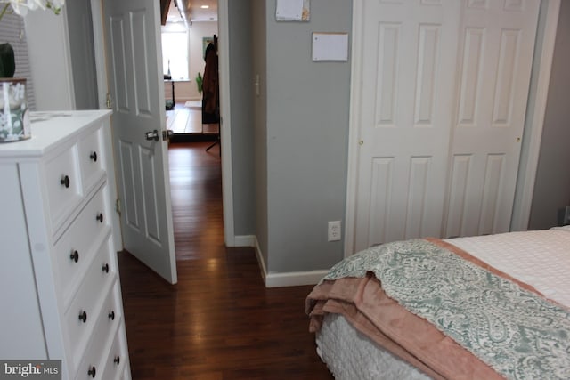 bedroom with dark hardwood / wood-style flooring