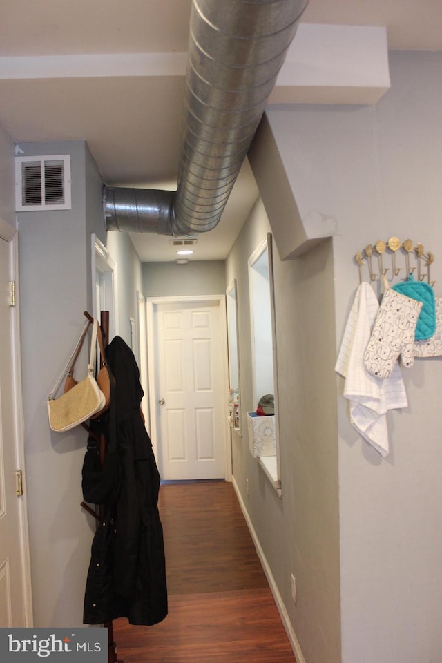 corridor featuring dark hardwood / wood-style flooring