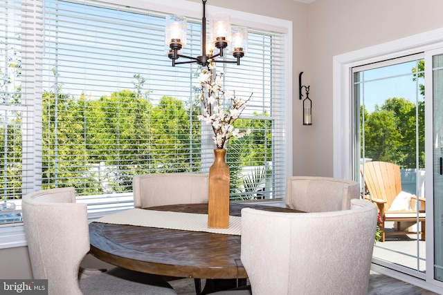 dining room featuring hardwood / wood-style flooring and an inviting chandelier