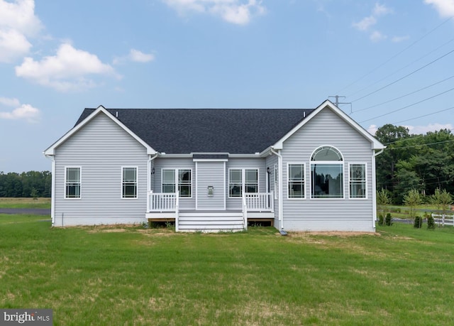 rear view of property featuring a yard