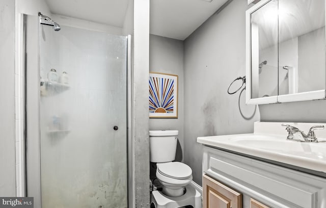 bathroom featuring vanity, toilet, and walk in shower