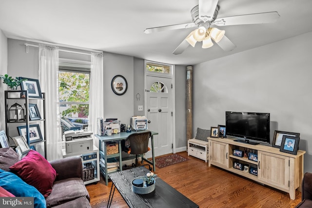 living room featuring dark hardwood / wood-style flooring and ceiling fan