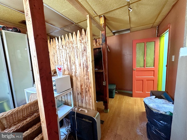 interior space featuring hardwood / wood-style flooring and a paneled ceiling