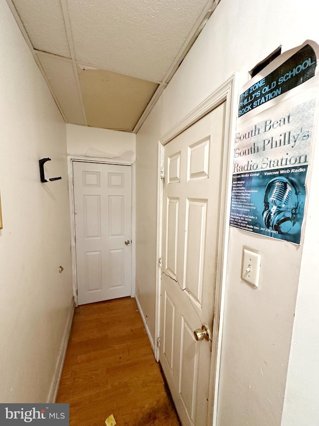 hallway with hardwood / wood-style flooring