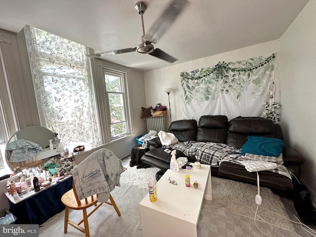 living room featuring carpet flooring and ceiling fan