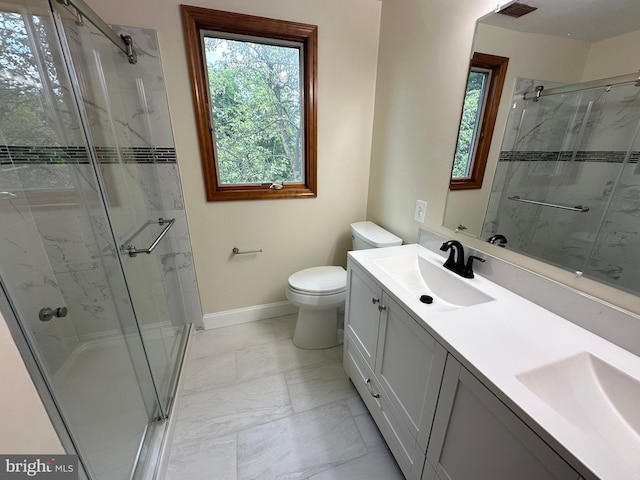 bathroom with tile patterned flooring, walk in shower, double vanity, and toilet