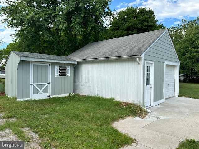 view of outbuilding with a garage and a yard