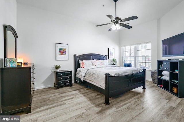 bedroom with light hardwood / wood-style flooring and ceiling fan