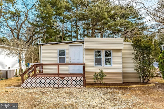 view of front facade with a deck and cooling unit