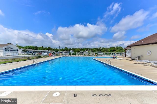 view of swimming pool featuring a patio area