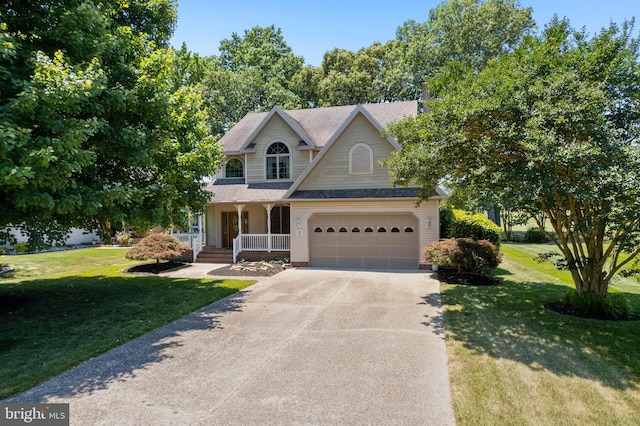 view of front of property with covered porch, a garage, and a front lawn