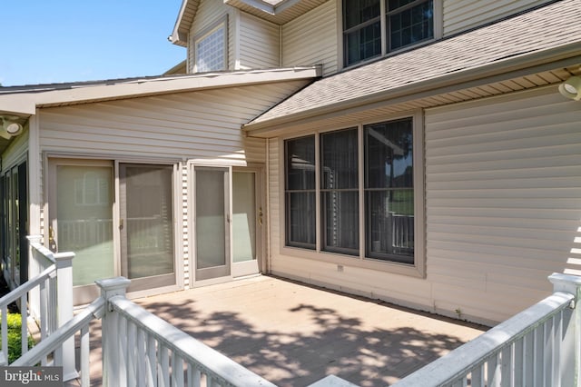 view of exterior entry featuring a wooden deck