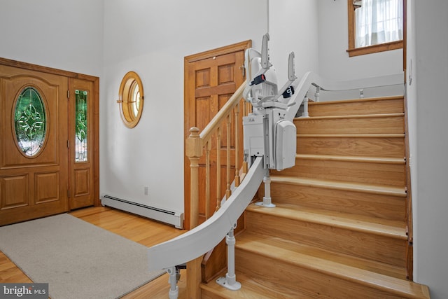 foyer featuring hardwood / wood-style floors and a baseboard radiator